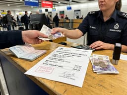 A courier holding packages, illustrating customs duties explained.
